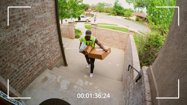packages being delivered to a home, as seen from a security camera.